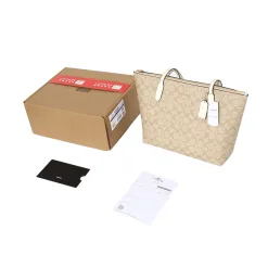 Hochwertige Coach-Jeans im Monogramm-Stil aus weißem Canvas